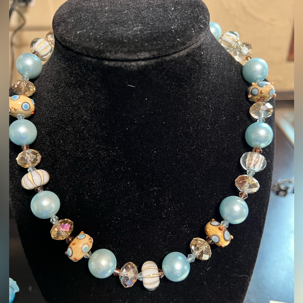 Glass and acrylic wedding cake beaded necklace 18” long which includes clasp.